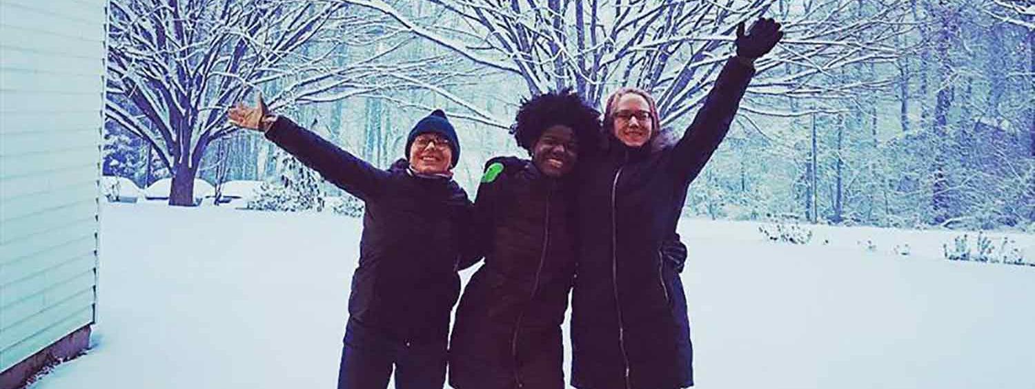 A photo of the three new National Players, posing in the snow 