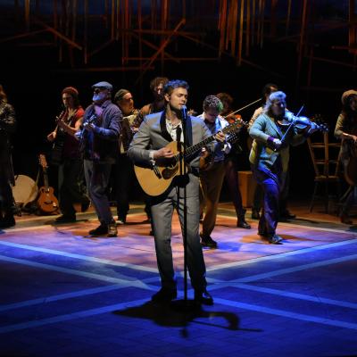 A production photo of the cast on stage